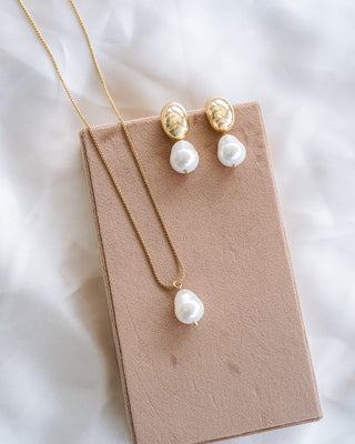 Hailey Dome Earrings and Necklace on beige board with white satin background