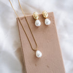 Hailey Dome Earrings and Necklace on beige board with white satin background