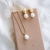 Hailey Dome Earrings and Necklace on beige board with white satin background