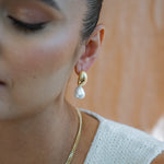 Hailey Dome Earrings on models earlobe