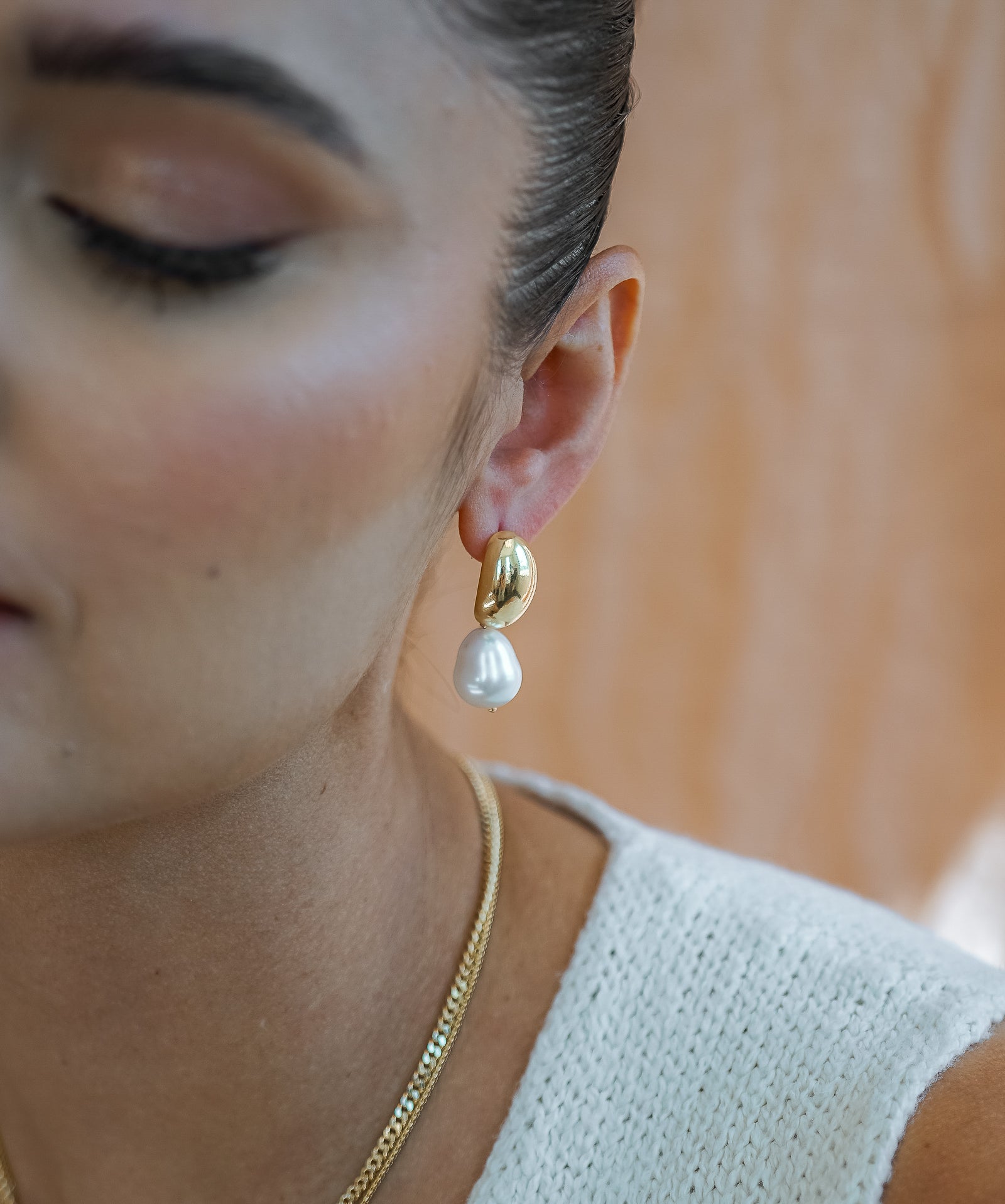 Hailey Dome Earrings on models earlobe