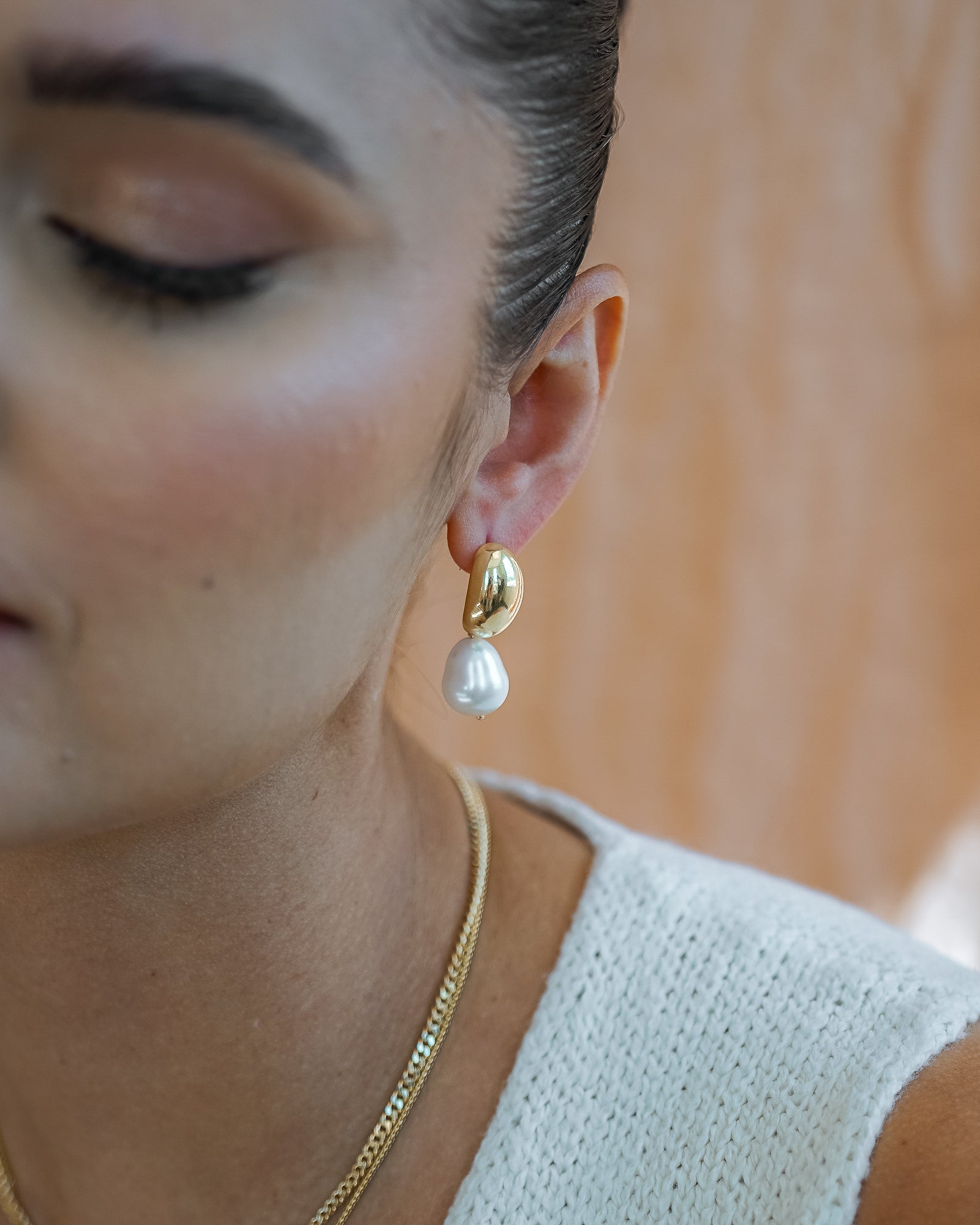 Hailey Dome Earrings on models earlobe