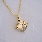Gold necklace with a detailed pendant on a white background
